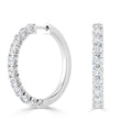 White gold hoop earrings adorned with round-cut diamonds, shown from the side and front views.