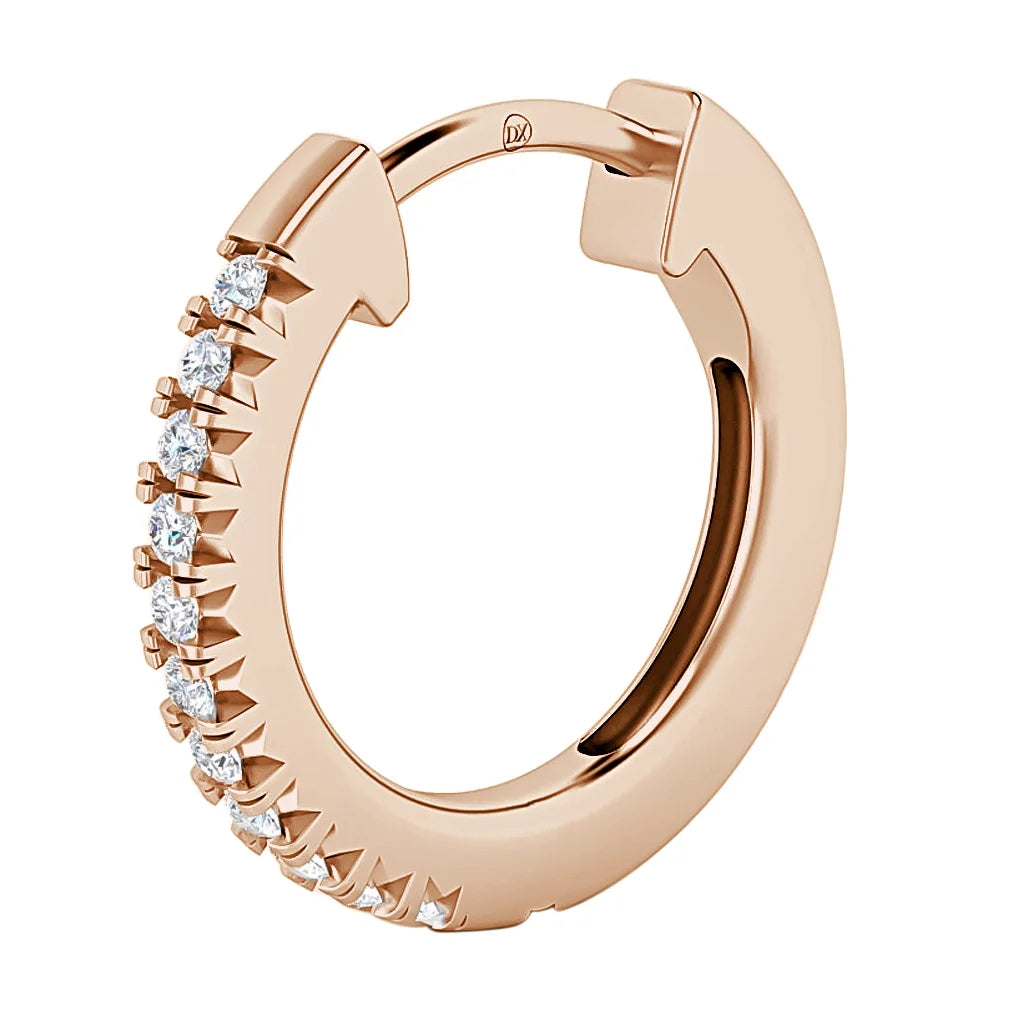 Rose gold hoop earring with small white gemstones set along half of the outer edge.