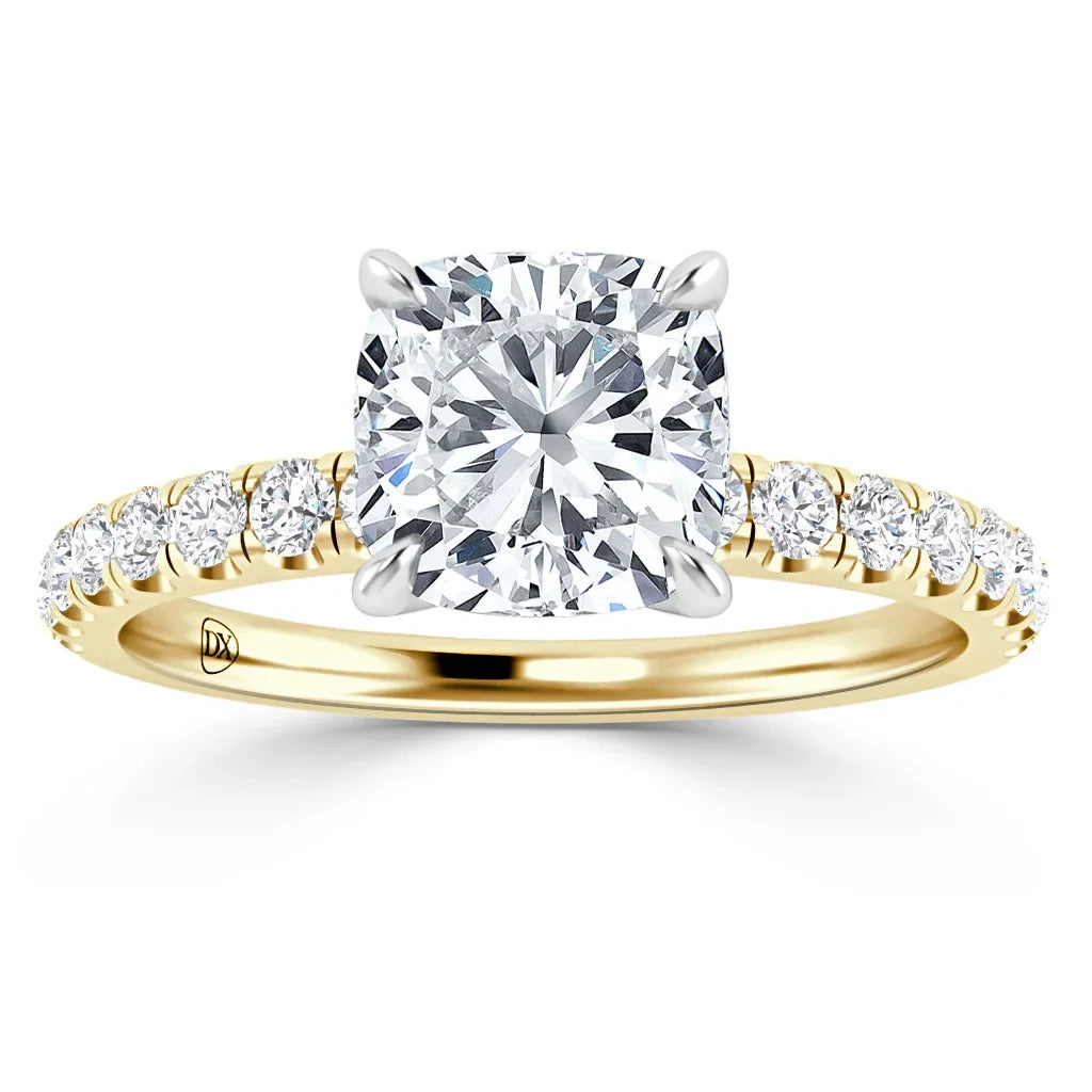 Gold ring with a large cushion-cut diamond center and smaller diamonds on the band, viewed from the front.