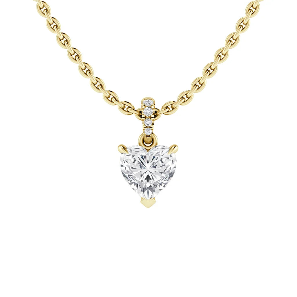 Gold chain necklace with a heart-shaped diamond pendant and three small round diamonds above the heart.