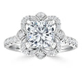 Platinum ring with a large square diamond center, surrounded by a floral halo of small round diamonds.