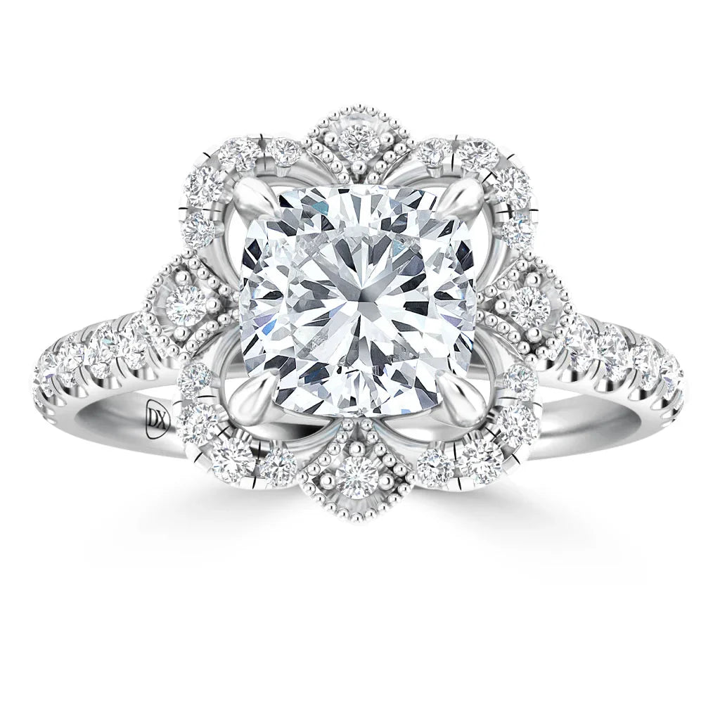 Platinum ring with a large square diamond center, surrounded by a floral halo of small round diamonds.