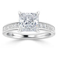 Platinum ring with a large princess-cut diamond center and smaller diamonds set along the band.