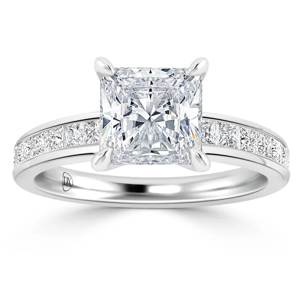 Platinum ring with a large princess-cut diamond center and smaller diamonds set along the band.