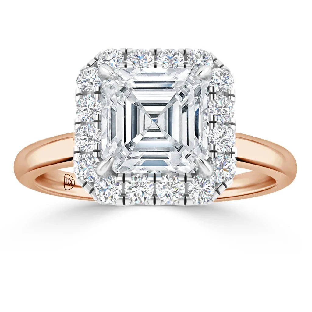 Rose gold ring with a square-cut diamond center and a halo of smaller round diamonds around it.