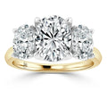 Three-stone diamond ring with a gold band and large, round-cut diamonds in a prong setting.
