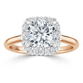 Rose gold ring with a round center diamond, surrounded by a square halo of smaller diamonds.