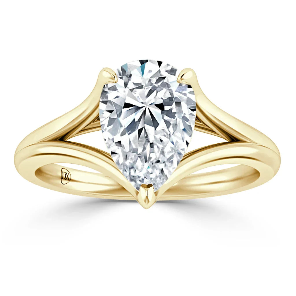 A pear-shaped diamond ring with a split yellow gold band and pointed prongs on a white background.
