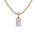 A gold chain necklace with an emerald-cut diamond pendant and small round diamonds on the pendant’s bail.