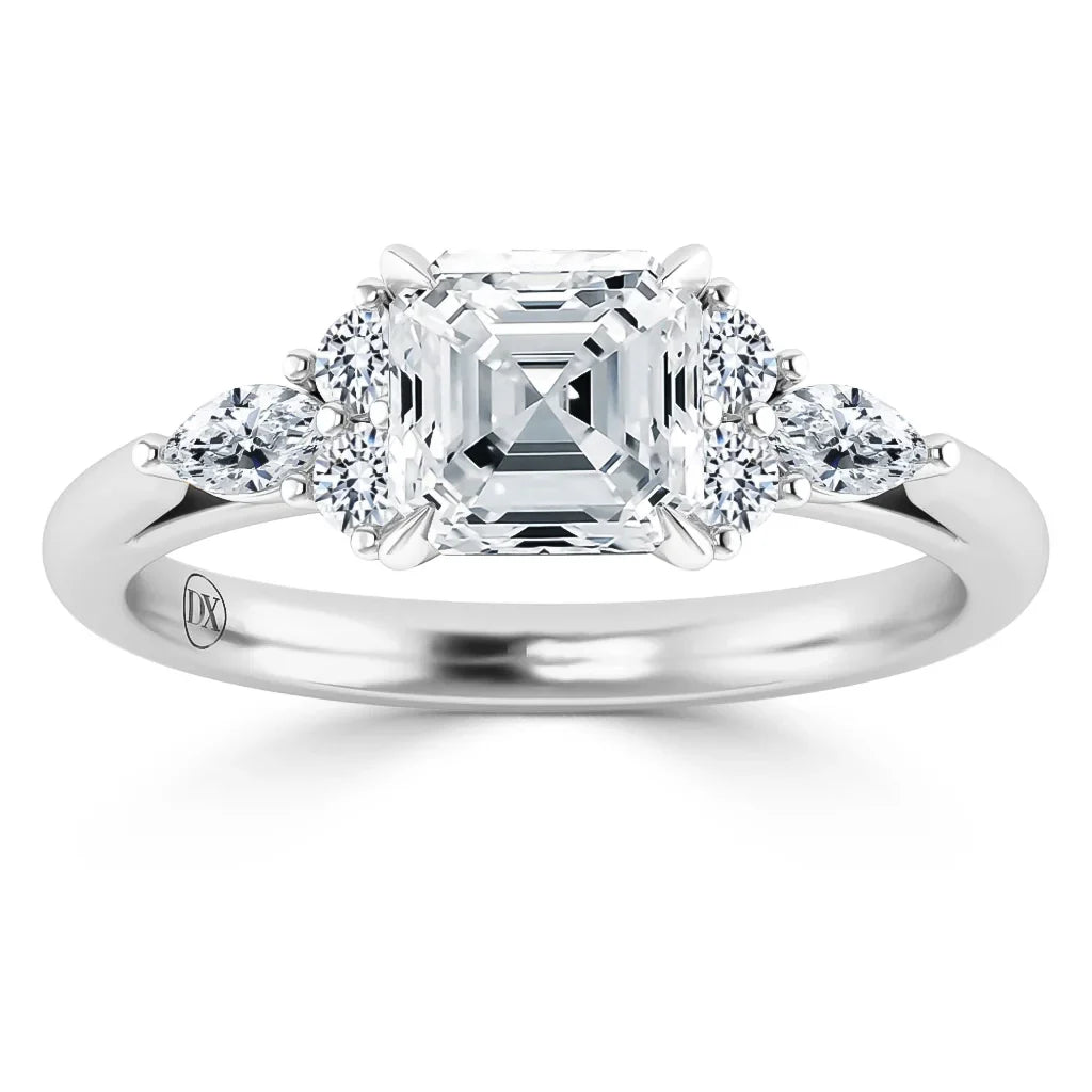 A platinum ring with an Asscher-cut diamond center and four round side diamonds on a plain band.