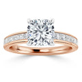 A rose gold ring with a cushion-cut diamond center and small diamonds set along the band.