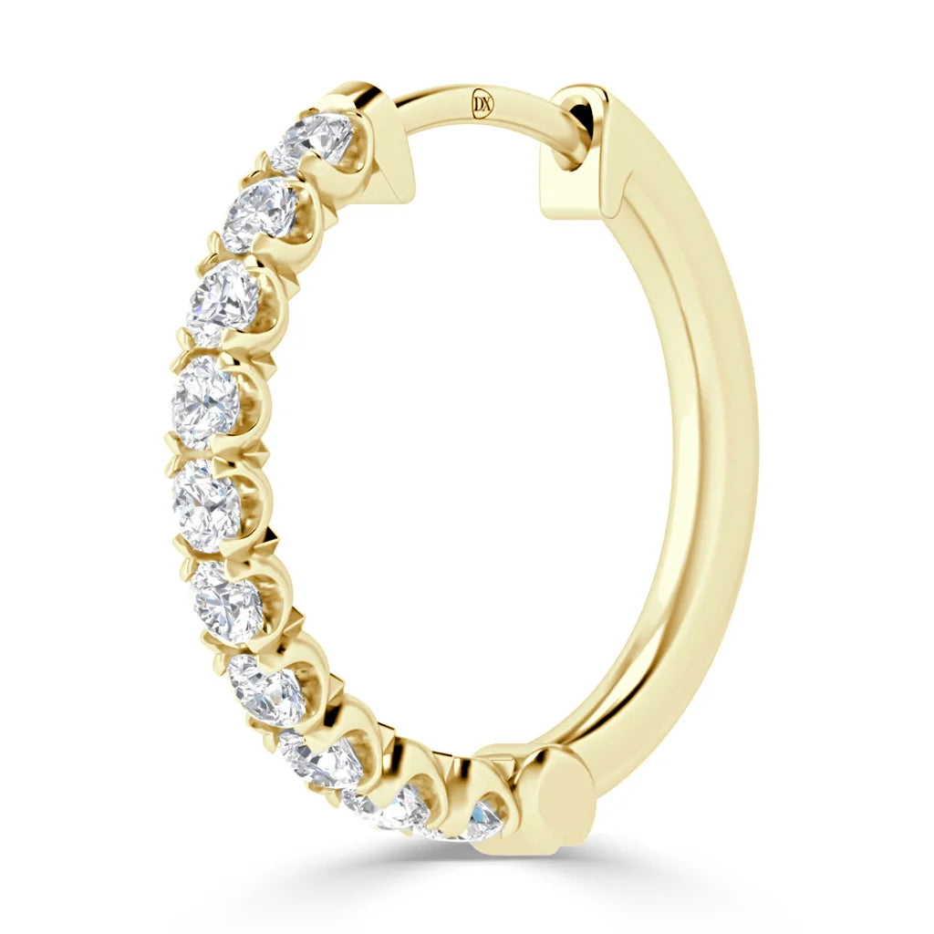 Gold hoop earring with a row of round, prong-set white diamonds on the front outer edge.