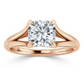 Rose gold ring with a cushion-cut diamond solitaire held by four prongs and a split shank band.