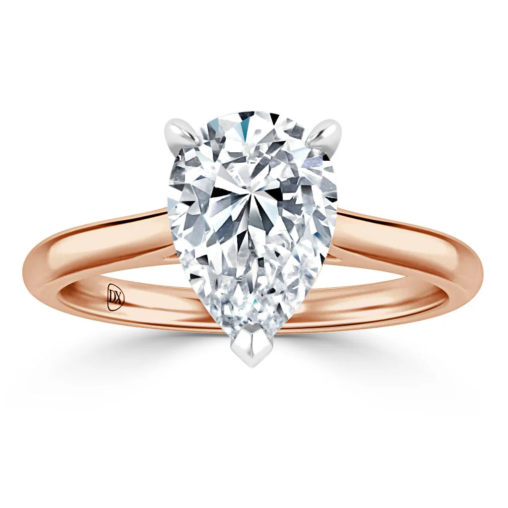 Rose gold ring with a large pear-shaped diamond solitaire in a simple prong setting, viewed from the front.