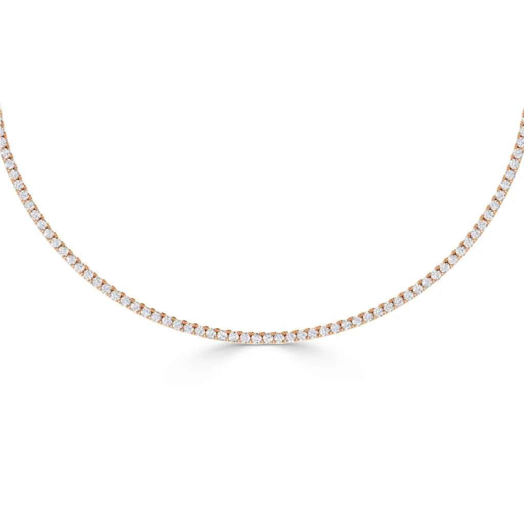 Rose gold tennis necklace with small round white diamonds set closely along the chain, shown on a white background.