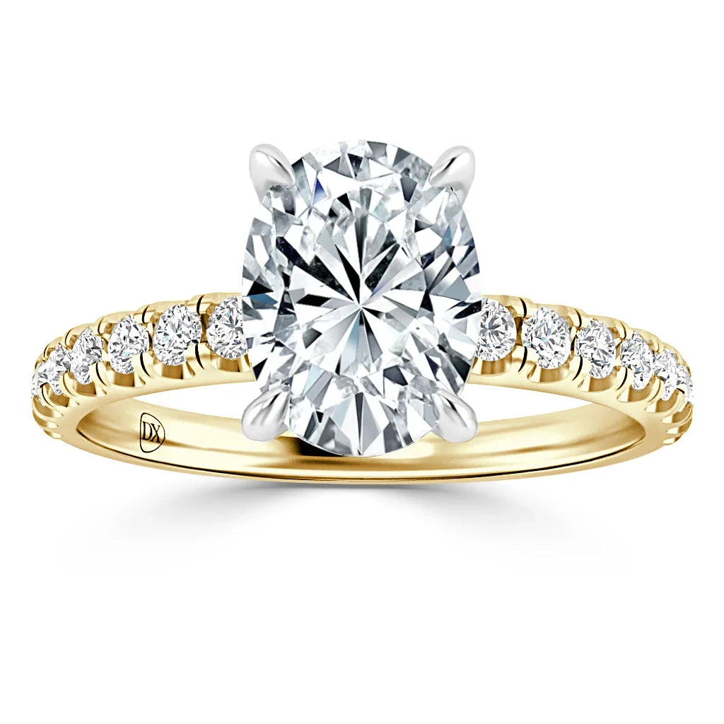 Yellow gold ring with an oval diamond center and round diamonds set along the band, shown on white background.