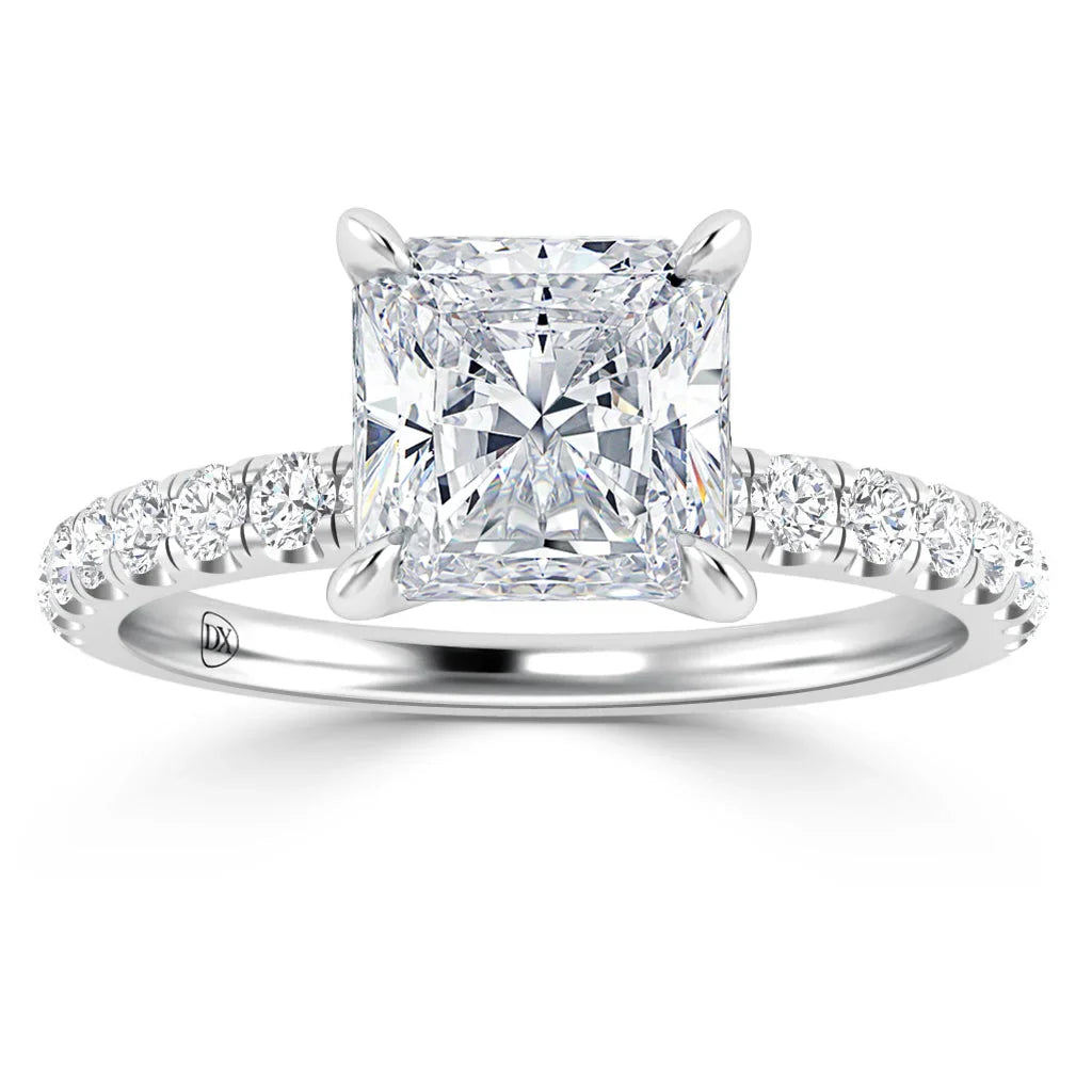 Platinum ring with a large princess-cut diamond center and small diamonds on the band.