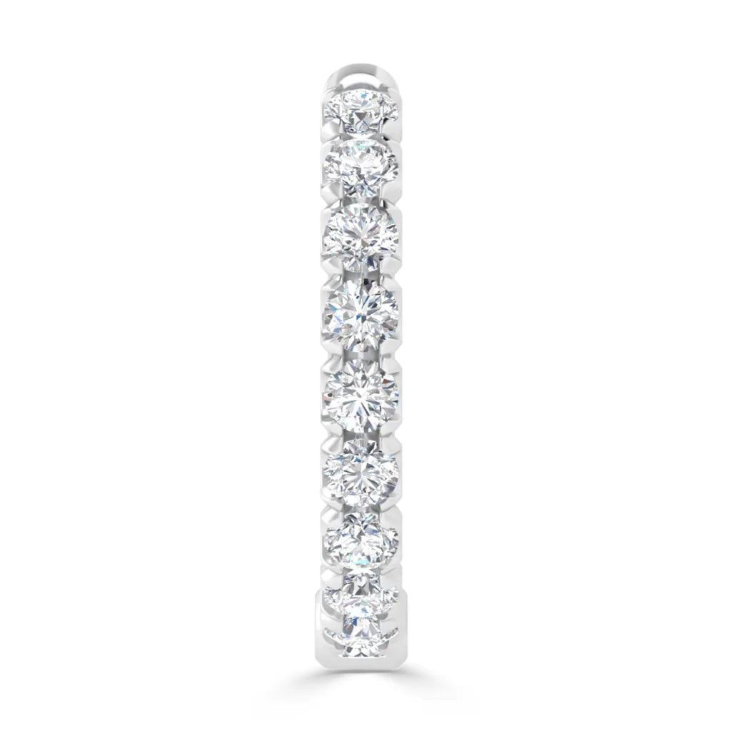 A vertical white gold earring set with nine round, sparkling diamonds in a single row.