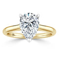 A pear-shaped diamond solitaire ring with a yellow gold band set in a classic prong setting.