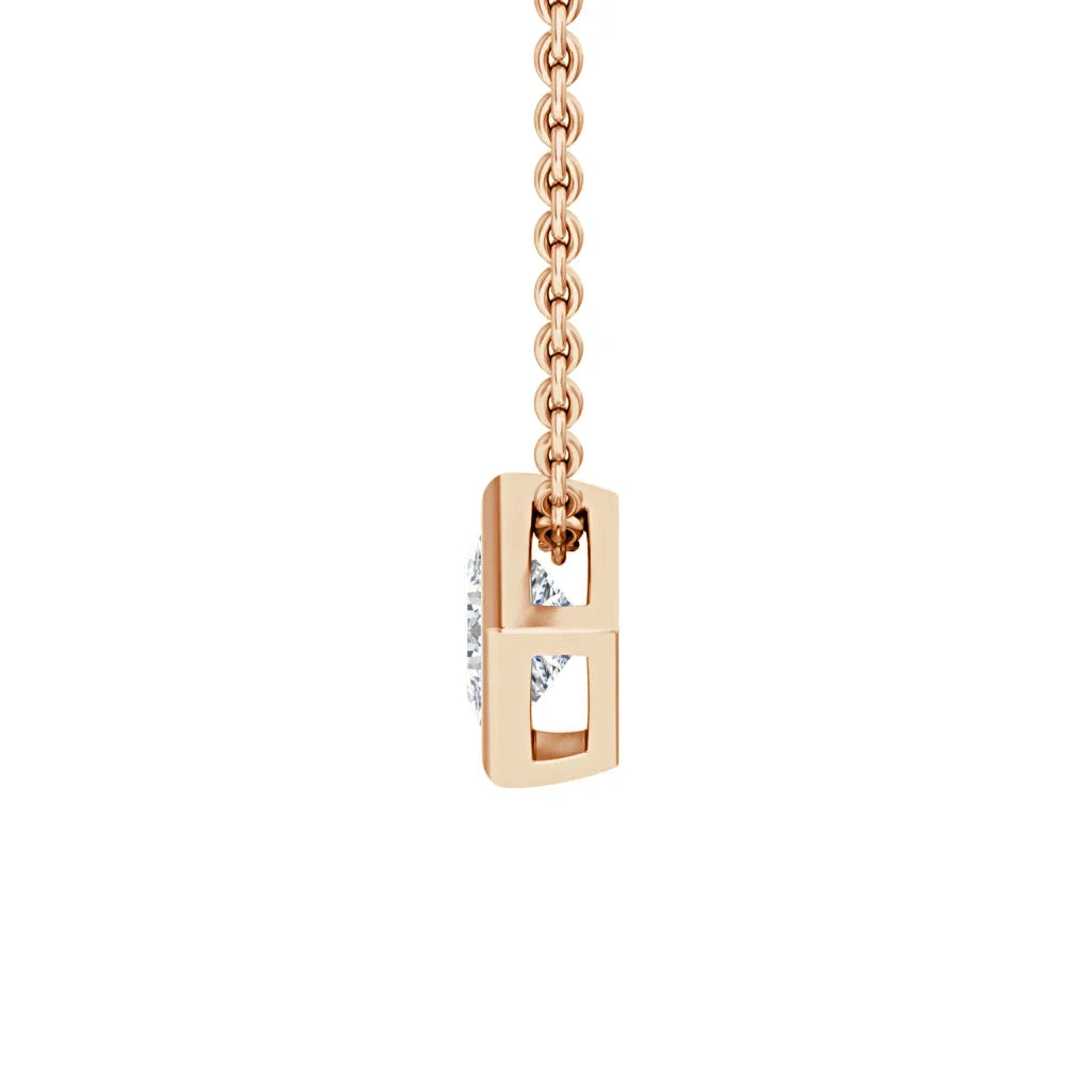 A gold necklace with a rectangular pendant featuring open sections and a visible diamond in the center.