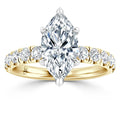 Gold ring with a marquise-cut diamond center and round diamonds set along the band.
