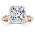 A rose gold ring with a square halo setting, featuring a large central diamond and pavé diamond band.