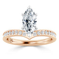 A marquise-cut diamond ring with a rose gold band set with small round diamonds in a curved design.