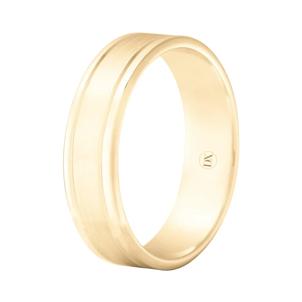 A plain yellow gold wedding band with a polished finish and a subtle groove near one edge, on a white background.