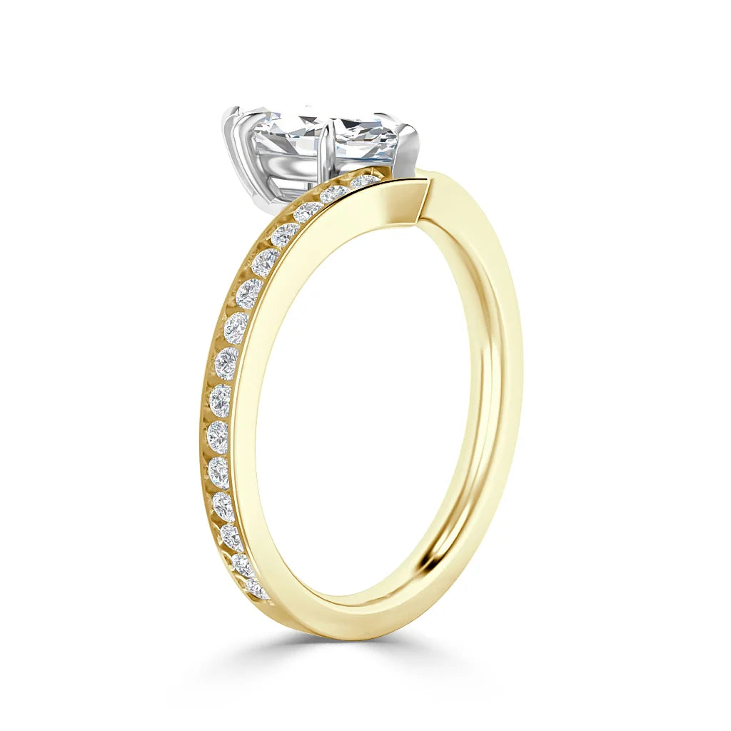 Gold ring with side diamonds and a large solitaire diamond in a silver prong setting on a white background.