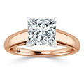 Rose gold ring with a square-cut diamond solitaire set in four prongs, shown on a white background.