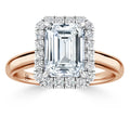 Emerald-cut diamond ring with a halo of small diamonds set on a rose gold band, displayed on white background.