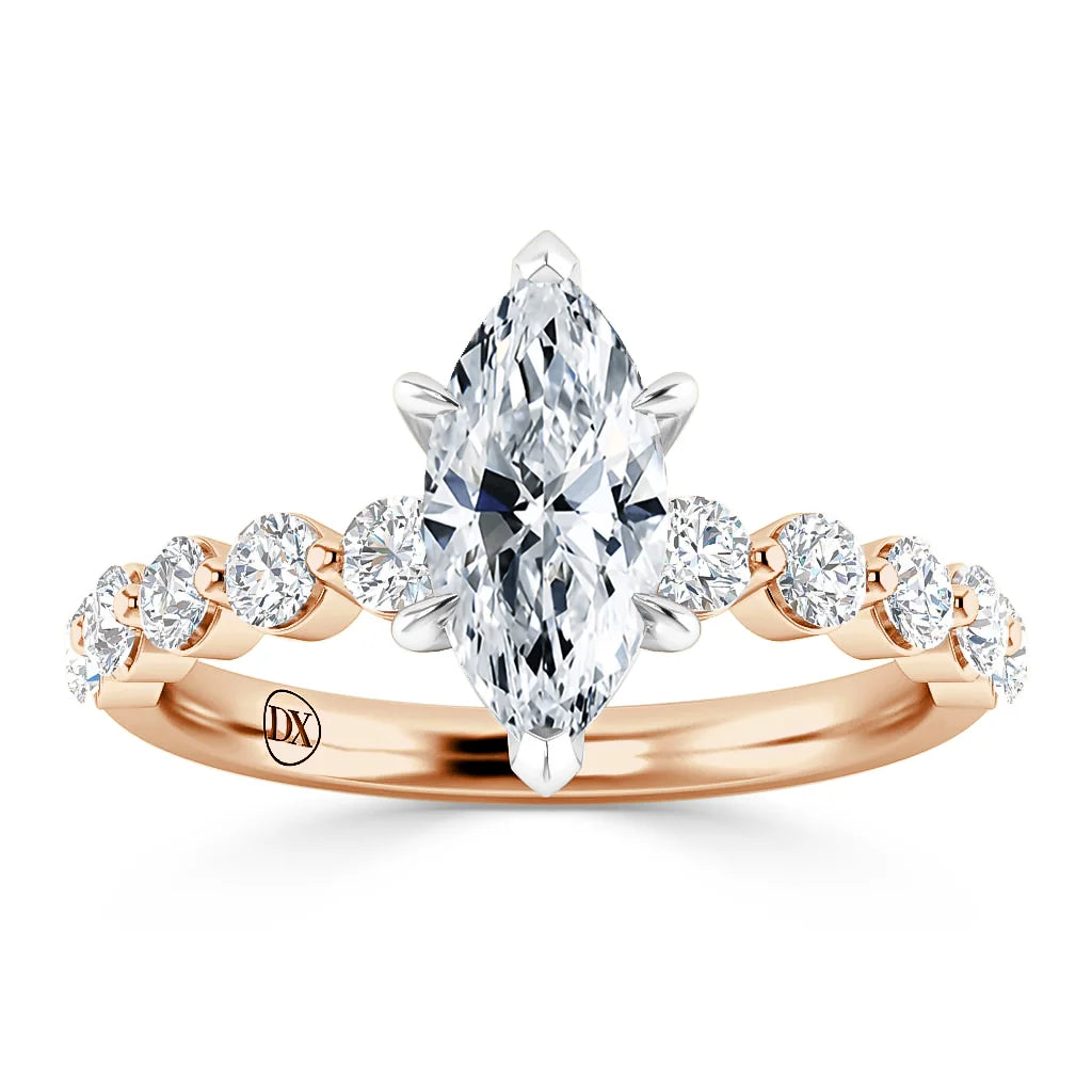 Rose gold ring with a large marquise diamond center and round diamonds set along the band.