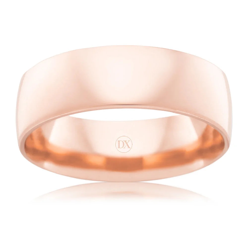 A plain, wide, polished rose gold ring with a smooth surface and a subtle DX engraving inside.