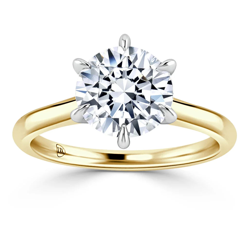 Gold band ring with a large round diamond solitaire in a six-prong setting on a white background.