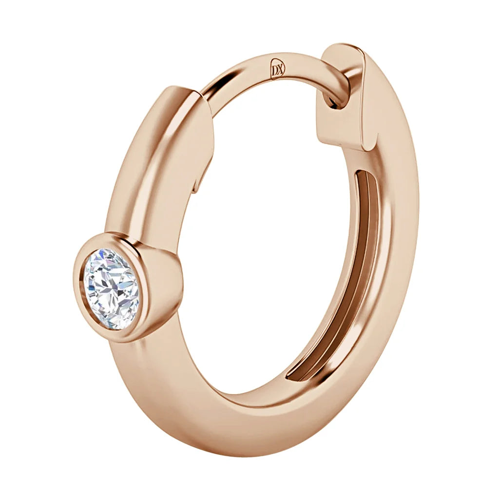 A rose gold hoop earring with a single round clear gemstone set in a bezel on the front.