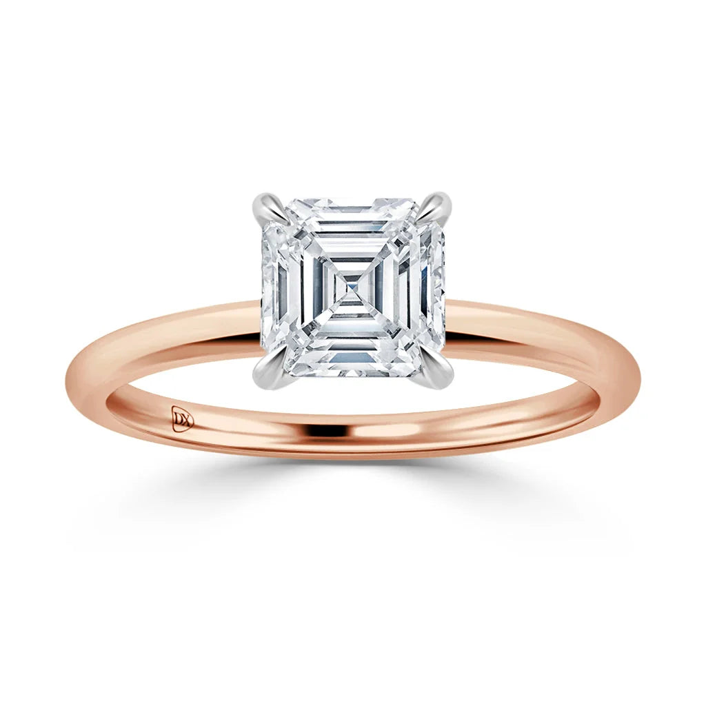 A rose gold band with an asscher-cut diamond solitaire set in a white gold prong setting.