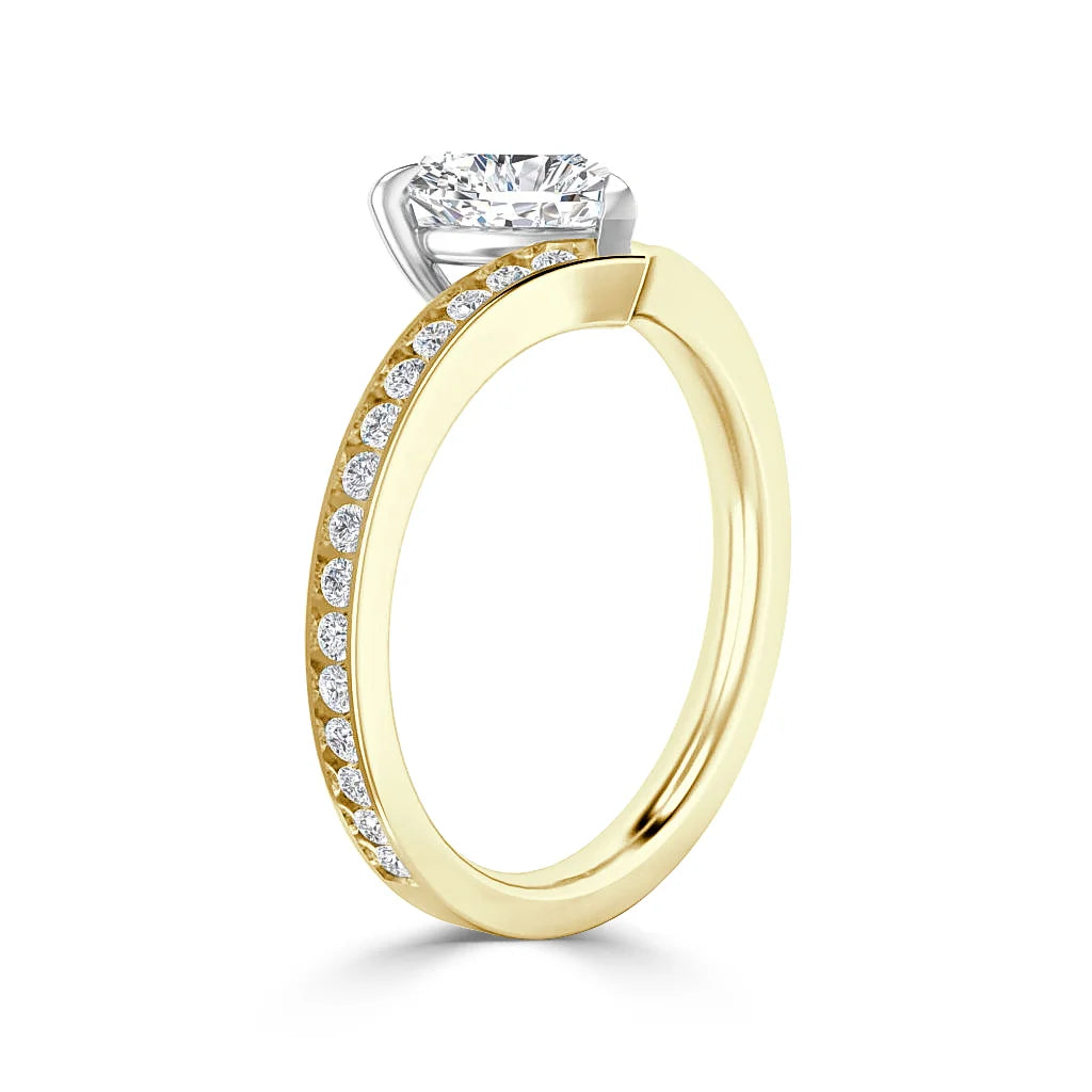 Gold ring with a row of small diamonds on the band and a large solitaire diamond in a prong setting.
