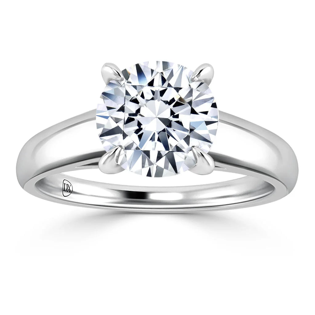 A solitaire diamond ring with a round, brilliant-cut diamond set on a plain white gold band.
