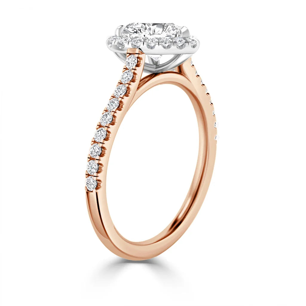 Rose gold engagement ring with a round halo diamond setting and diamond accents along the band.