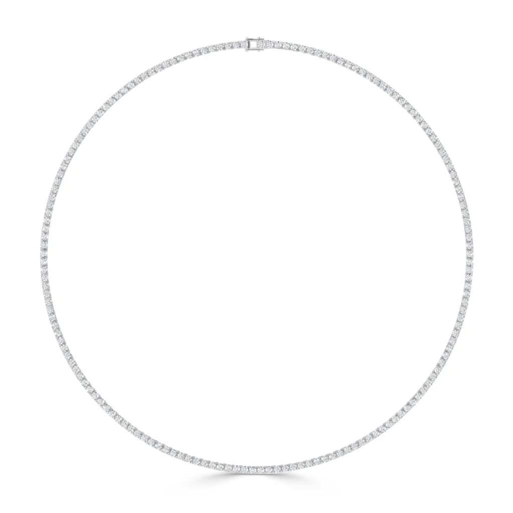 A thin, elegant tennis necklace with small, round, evenly spaced sparkling diamonds in a full circle.