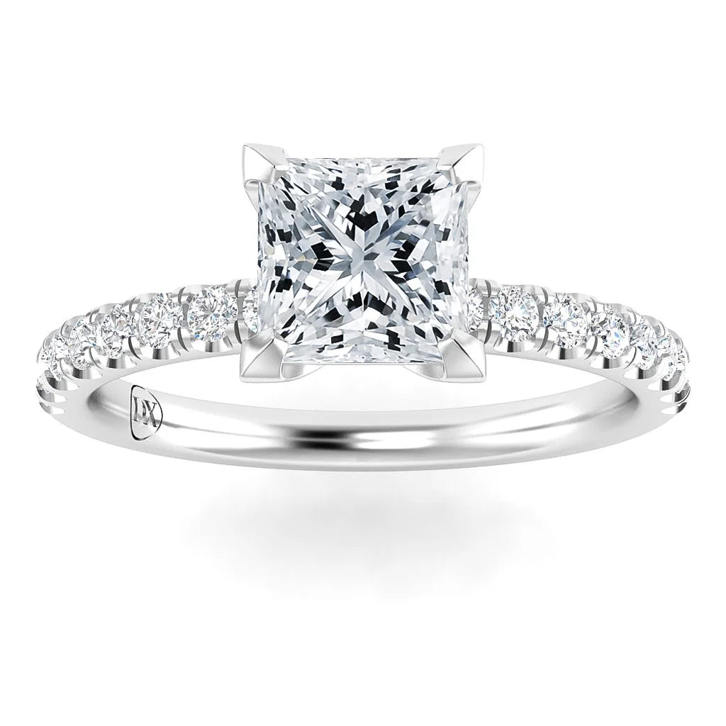 Platinum ring with a square-cut diamond center and a band adorned with small round diamonds.