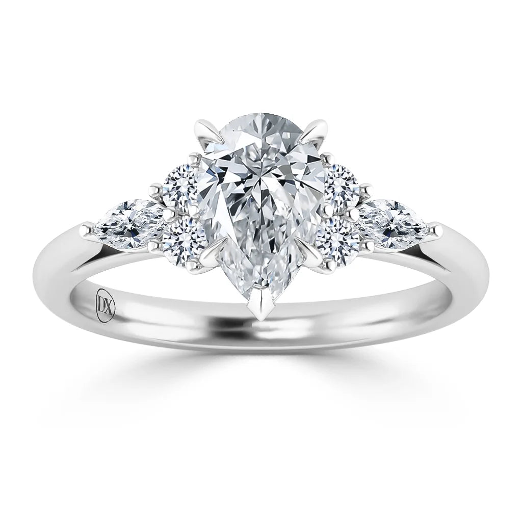 A pear-shaped diamond ring with five round side stones set in a polished white metal band.
