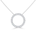 Silver necklace with a circular pendant encrusted with small clear diamonds, on a fine chain, white background.