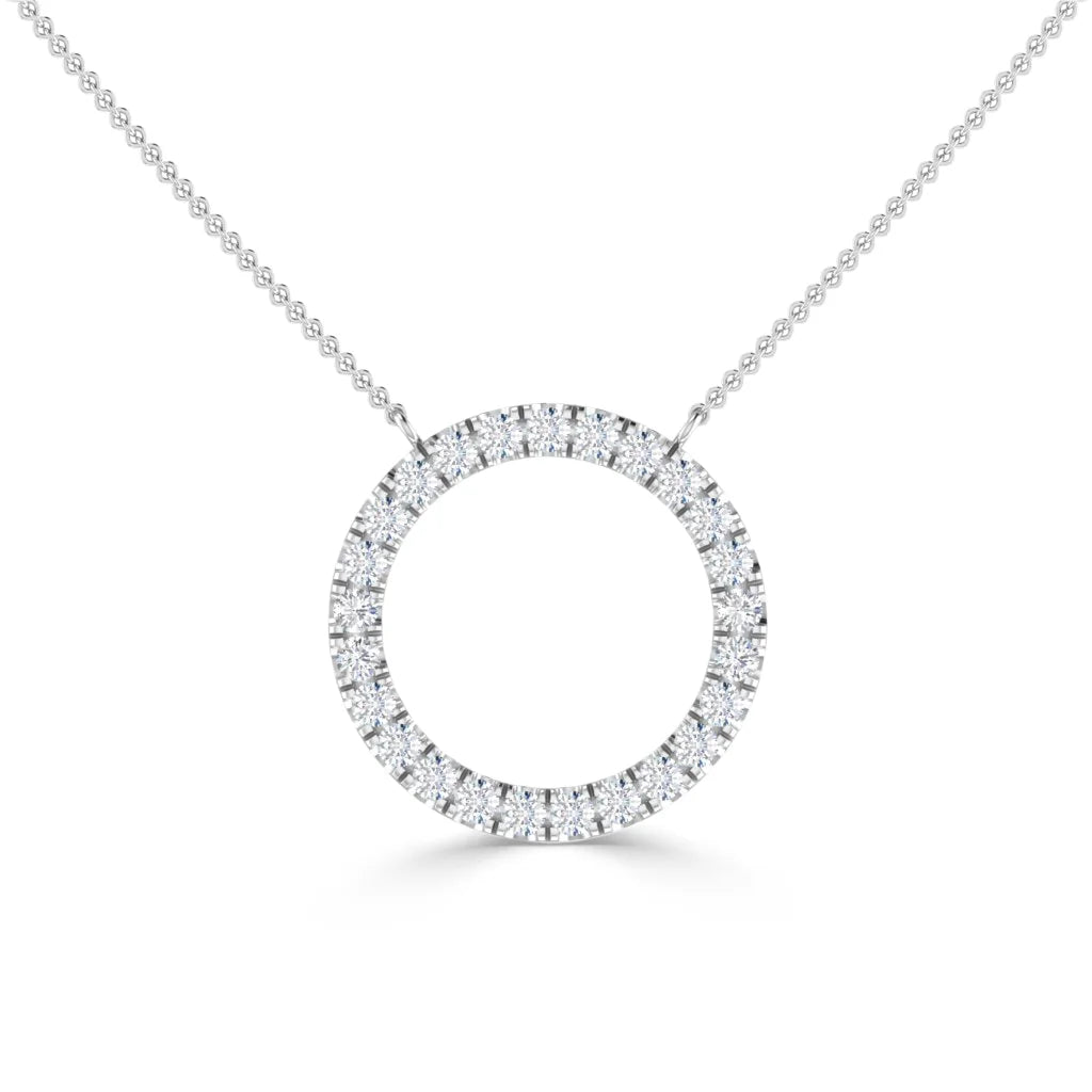 Silver necklace with a circular pendant encrusted with small clear diamonds, on a fine chain, white background.