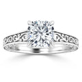 Silver ring with a large cushion-cut diamond and intricate filigree detailing along the band.