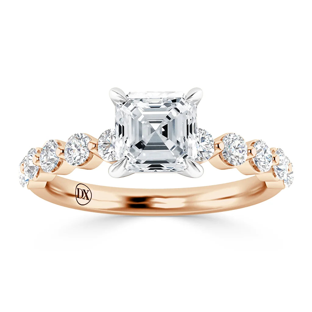 Rose gold ring with an Asscher-cut diamond center and round side diamonds on the band.