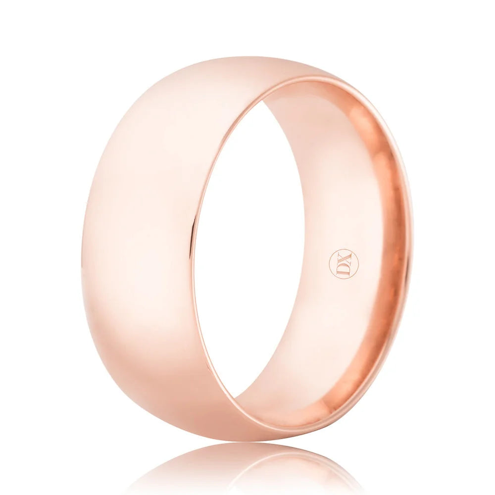 A plain, polished rose gold ring with a smooth, shiny finish and a small engraved logo inside.