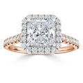 A rose gold ring with a square-cut diamond center, haloed by smaller diamonds and diamond accents on the band.
