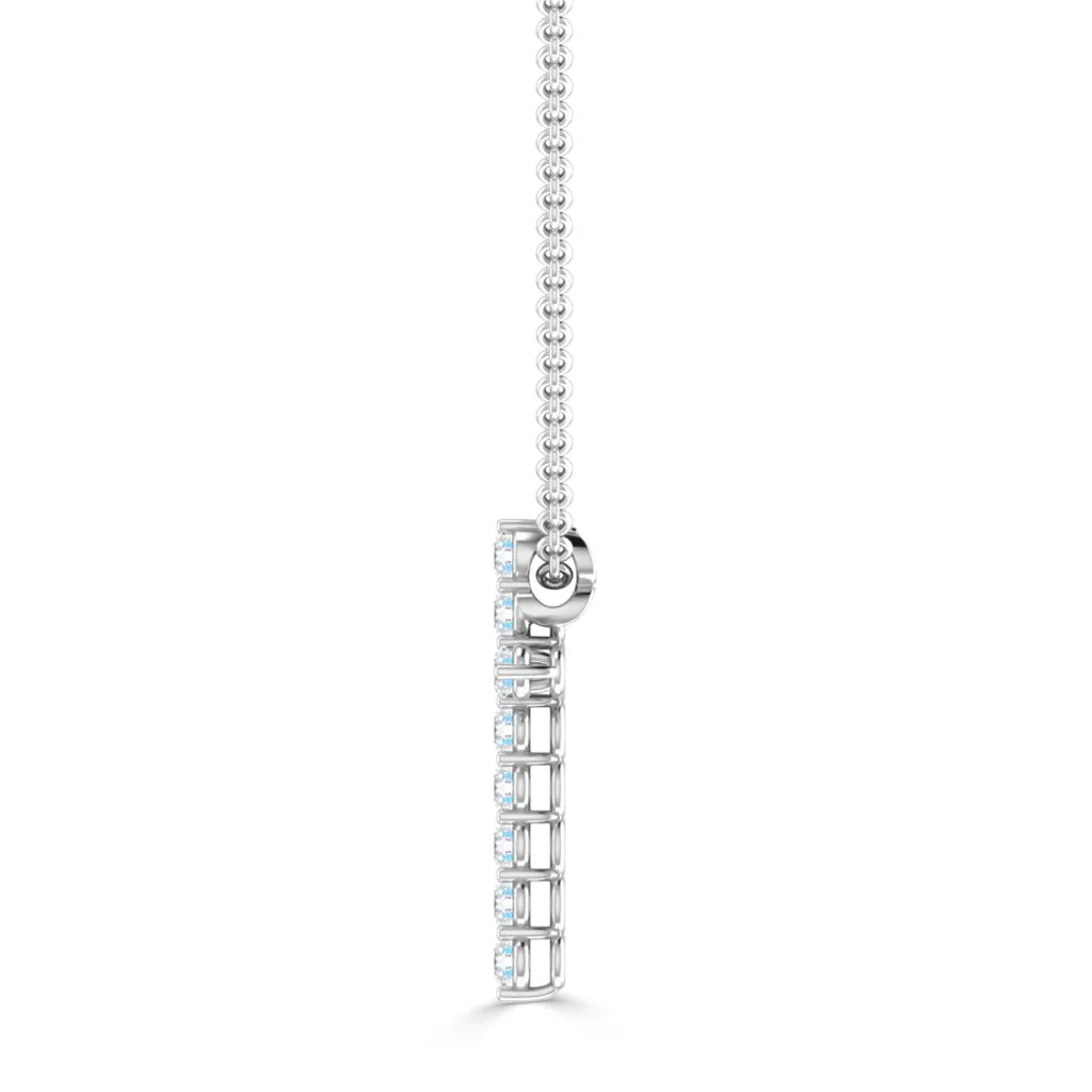 Side view of a silver necklace with a vertical pendant featuring a row of small, round clear stones.