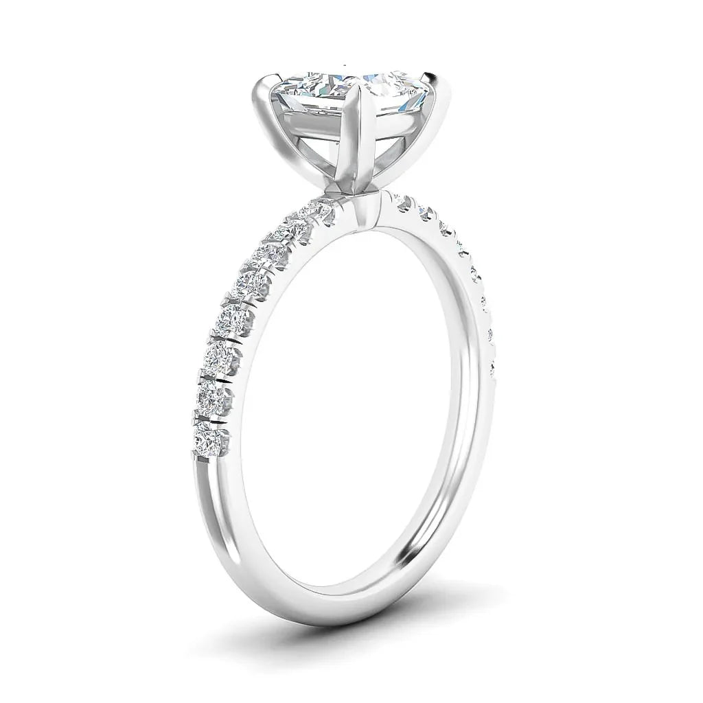 White gold engagement ring with a round solitaire diamond and small diamonds on the upper half of the band.